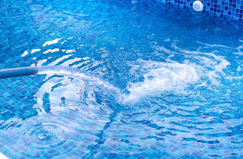 Filling,A,Newly,Installed,Pool,With,Water,With,A,Blue