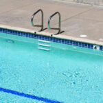 Elevated,View,Of,The,Outdoor,Swimming,Pool,With,Metal,Handrails