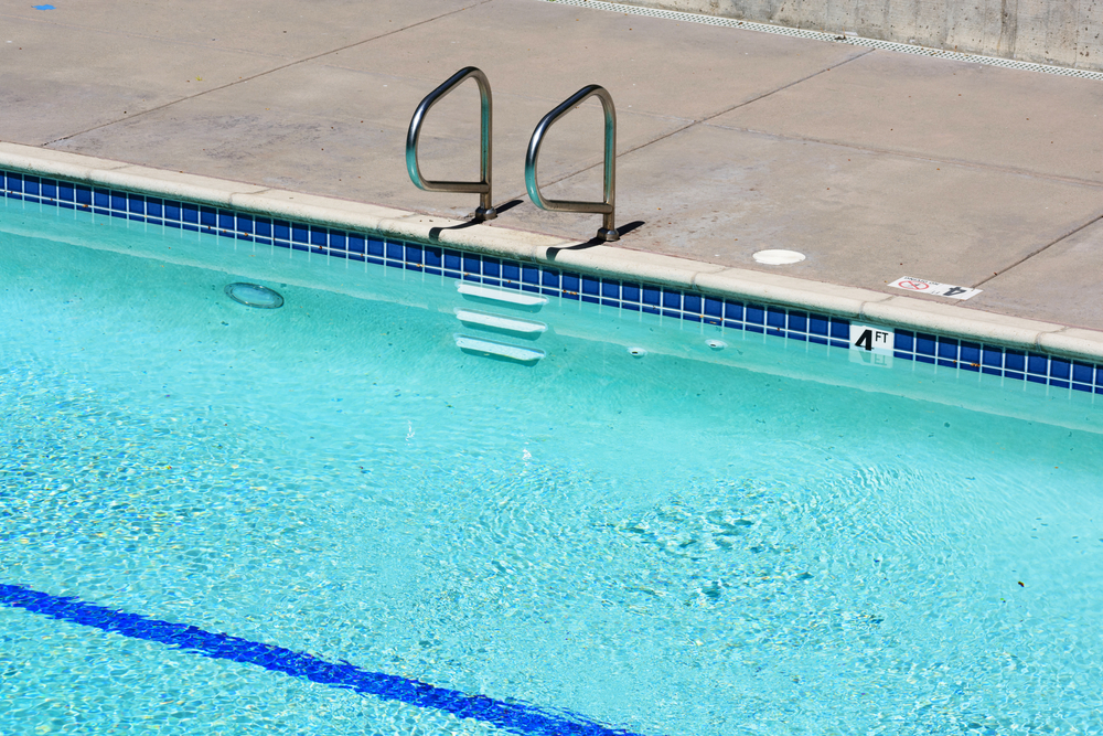 Elevated,View,Of,The,Outdoor,Swimming,Pool,With,Metal,Handrails