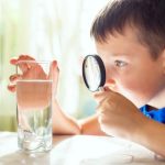 The,Child,Boy,Looking,At,Water,In,A,Glass,Through